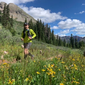 Simon Arendt running on a trail and smiling